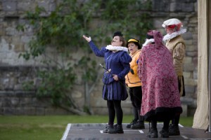 Actors of the Illyria Theatre Company on stage during an outdoor theatre performance of The Merry Wives of Windsor at Fountains Abbey, North Yorkshire